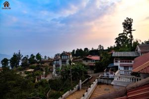 a view of a village with houses on a hill at CHOCOLATE VILLA Mahabaleshwar in Mahabaleshwar