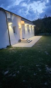 a white building with lights on the side of it at Veline Koper in Koper