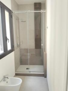 a bathroom with a glass shower and a sink at La Corte degli Scolopi in Palma di Montechiaro
