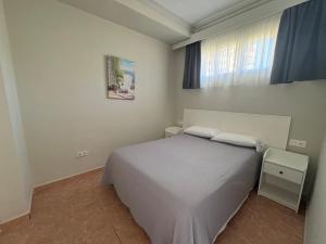 a bedroom with a white bed and a window at Apartamentos Los Jazmines in Torremolinos +22 photos