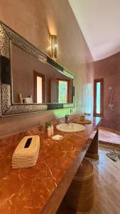 a large bathroom with a sink and a large mirror at Villa Amazonika By La Siredrah in Segraga +42 photos