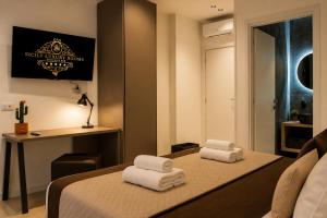 a room with a bed with towels on it at Sicily Luxury Rooms in Palermo +131 photos