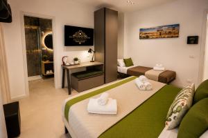 a hotel room with a bed and a living room at Sicily Luxury Rooms in Palermo