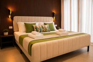 a bedroom with a large bed with towels on it at Sicily Luxury Rooms in Palermo