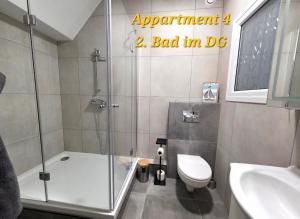 a bathroom with a shower and a toilet and a sink at SWINEMUENDE Ferienwohnung Speckmann in Świnoujście +13 photos