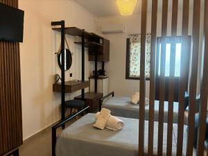 a bedroom with two bunk beds and a mirror at Thanos ,Rooms and Apartments in Ouranoupoli