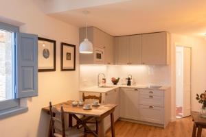 a kitchen with a table and a dining room at El Fort d'Ullastret in Ullastret