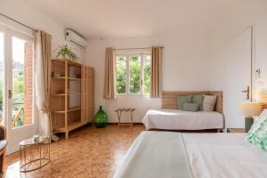 a white bedroom with two beds and a window at Allegria in Baiardo
