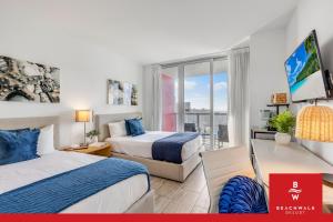 a hotel room with two beds and a window at Upper Studio Bay Balcony Pool & Shuttle in Hallandale Beach
