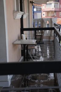 a table and chairs on the balcony of a building at SR99 Hotel in Tirana