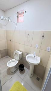 a bathroom with a toilet and a sink at Villa Marçal in São Mateus +14 photos