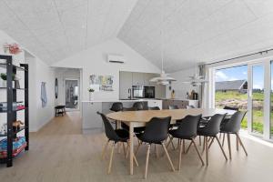 a kitchen and dining room with a table and chairs at LN2067-Hjorring-Gabet-7 in Lønstrup