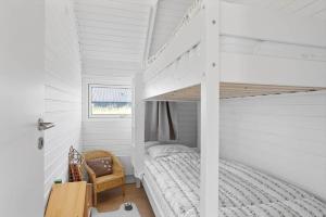 a bedroom with a bunk bed in a white room at LN2067-Hjorring-Gabet-7 in Lønstrup