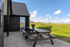 a picnic table and a bench on a patio at LN2067-Hjorring-Gabet-7 in Lønstrup