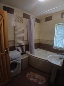 a bathroom with a tub and a toilet and a sink at Садиба Сонячний дім in Pilipets +35 photos