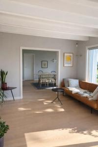 a living room with a couch and a table at Seaside House 5 BR in Garder