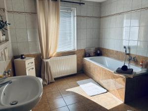 a large bathroom with a tub and a sink at Bella's Eden in Grimma +29 photos