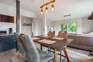 a kitchen and dining room with a table and chairs at Ferienwohnung 3 in Gribow