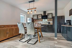 a kitchen with a wooden table and chairs at Ferienwohnung 3 in Gribow +18 photos