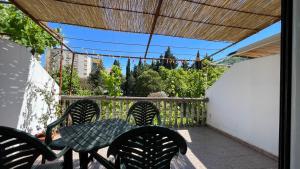 a patio with a table and chairs on a balcony at Golden Grape House in Budva