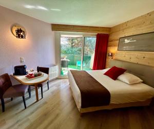 a bedroom with a bed and a desk and a table at Résidence Côté Chalet in Thonon-les-Bains