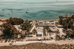 an aerial view of a beach with boats in the water at Sagredo Beachfront Retreat & Spa by E-GEO in Ágios Fokás