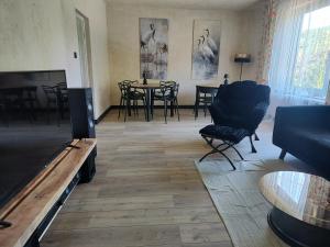 a living room with a tv and a table and chairs at Weekendowo Miejsce i Czas Agroturystyka in Wyszogród
