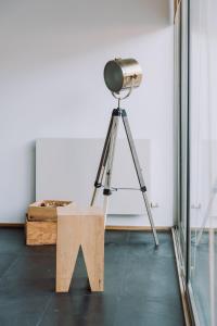 a camera on a tripod in a room with a table at Casa da Barca Pool & Golf by TonsdeVerde in Esposende +27 photos