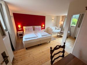 a bedroom with a bed and a red wall at Gasthaus Breitenbach in Bad Brückenau +52 photos