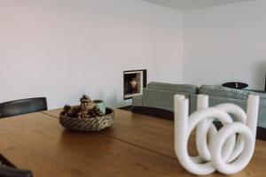 a living room with a table and a couch at Casa da Barca Pool & Golf by TonsdeVerde in Esposende