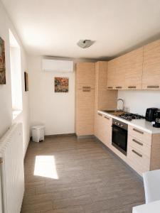 a kitchen with wooden cabinets and a stove top oven at Rustico Maria Full House Lake View Escape in Vercana