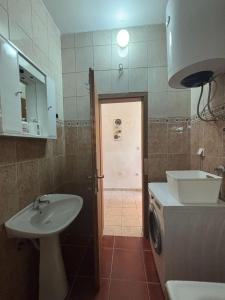 a bathroom with a sink and a washing machine at Apartments Vukasović in Kotor +35 photos