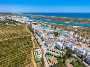 an aerial view of a resort near the beach at Roots Villa - Casa das Árvores in Cabanas de Tavira