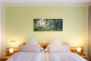 a bedroom with two beds and a painting on the wall at Lina's Rhön in Bad Brückenau