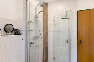 a bathroom with a shower with a glass door at Lina's Rhön in Bad Brückenau +13 photos
