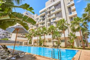 an image of a swimming pool in front of a building at Stunning Studio Pool View CFC Casablanca in Casablanca