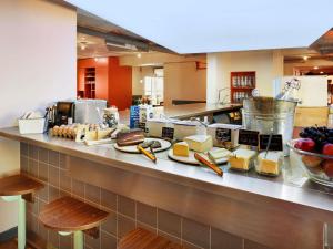 a buffet line with cheese and other food items at Greet Hotel Nice Aéroport Promenade des Anglais in Nice