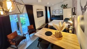 a living room with a bed and a table in a room at Apartmány Benešov in Benešov nad Ploučnicí