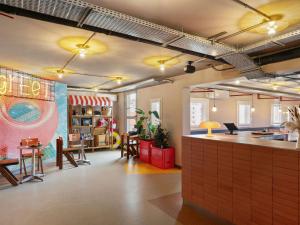a room with a restaurant with a counter and tables at Greet Hotel Nice Aéroport Promenade des Anglais in Nice