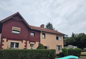a house with a red roof at Small, cozy tiny apartment, complete in Lichtenau