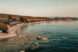 a large body of water next to a beach at Sagredo Beachfront Retreat & Spa by E-GEO in Ágios Fokás +77 photos