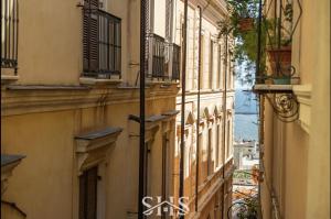 an alley between two buildings with balconies at Marco's stylish home In the heart of Cagliari in Cagliari