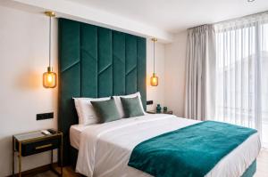 a bedroom with a large bed with a green headboard at Palheiro 81 Ocean View in Costa Nova +28 photos