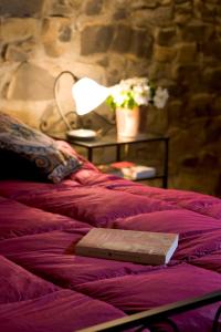 A bed or beds in a room at Rimaggiori Country Home & Restaurant