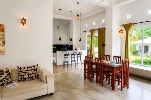 a kitchen and living room with a table and chairs at Everdew Kandy in Kandy