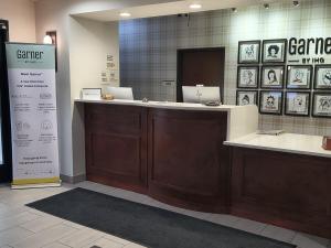 a counter in a store with two laptops on it at Grander Inn & Suites by IHG in Tyler