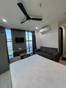 a bedroom with a large bed and a couch at Hotel 7 Square in Surat