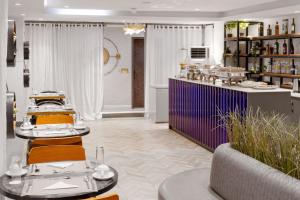 a salon with two tables and chairs in a room at Yellow Trumpet Iris Maitama in Abuja