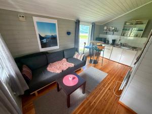a living room with a couch and a table at Mørsvikbotn Camping AS in Mørsvik