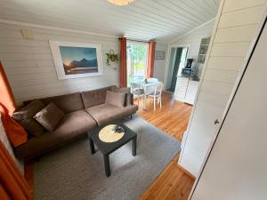 a living room with a couch and a table at Mørsvikbotn Camping AS in Mørsvik